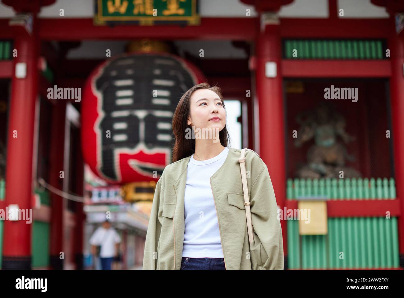 A woman standing in front of a temple Stock Photo