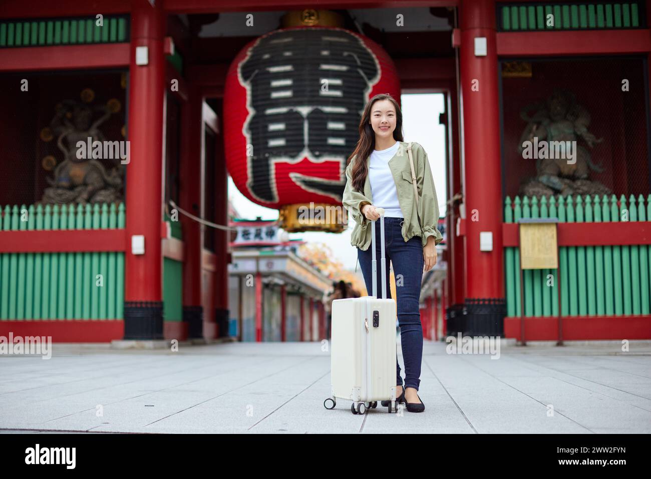 A woman standing in front of a temple Stock Photo