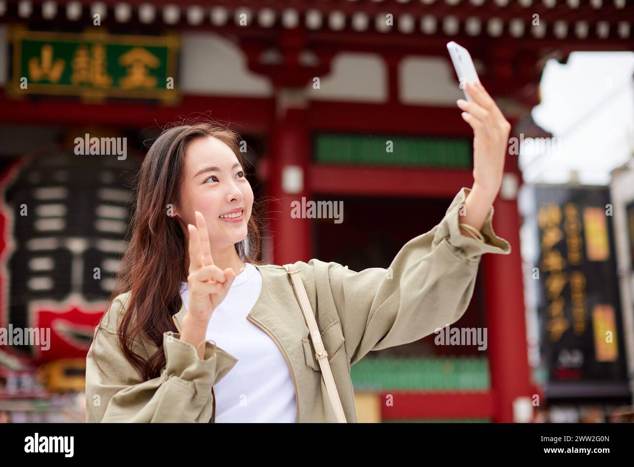 Asian woman taking selfie in front of a temple Stock Photo