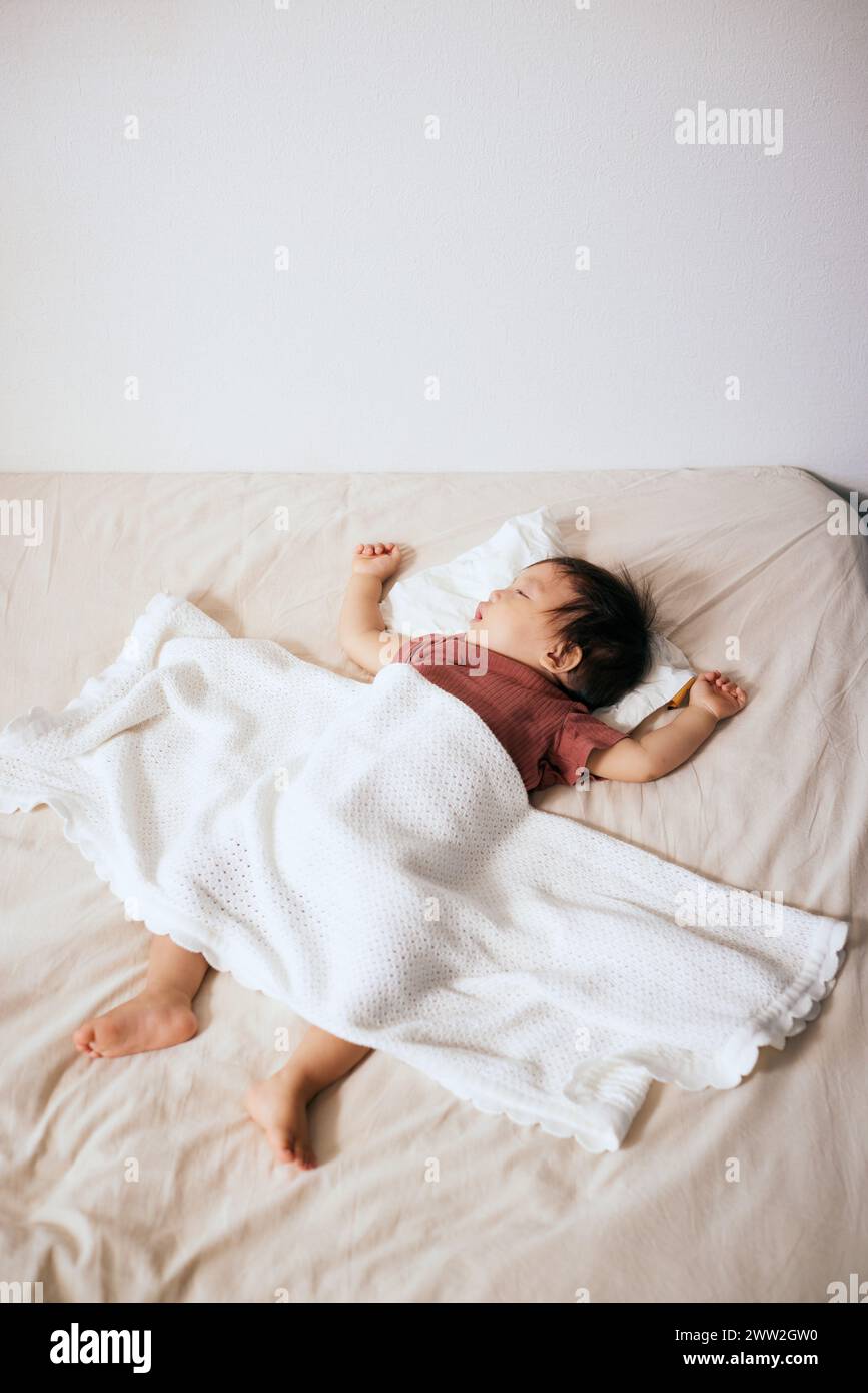 Asian boy sleeping in bed hi-res stock photography and images - Alamy