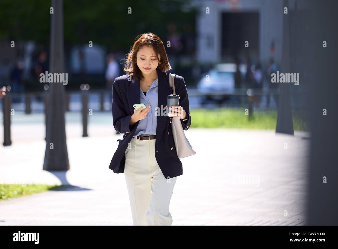 A woman walking down the street Stock Photo
