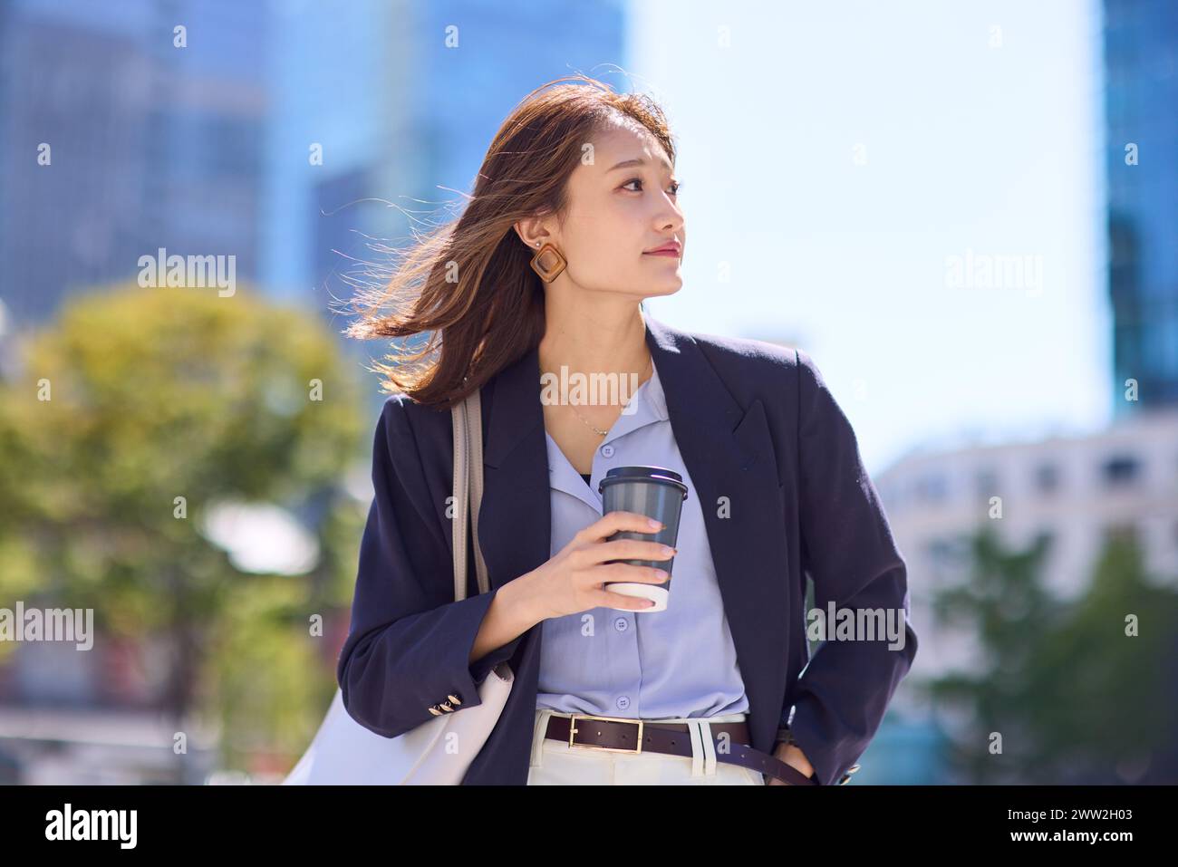 Asian business woman with coffee in the city Stock Photo