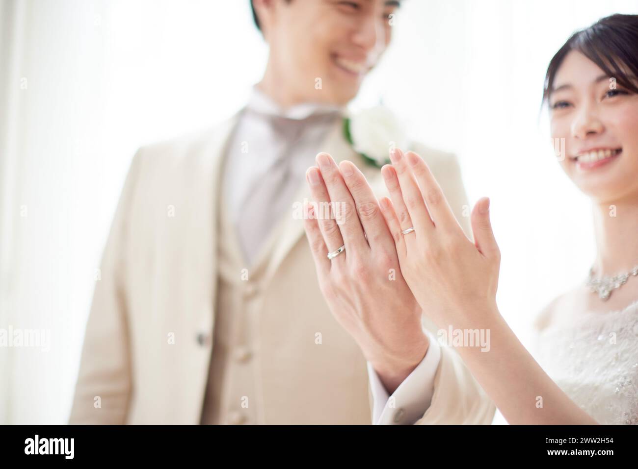 Bride and groom showing rings Stock Photo