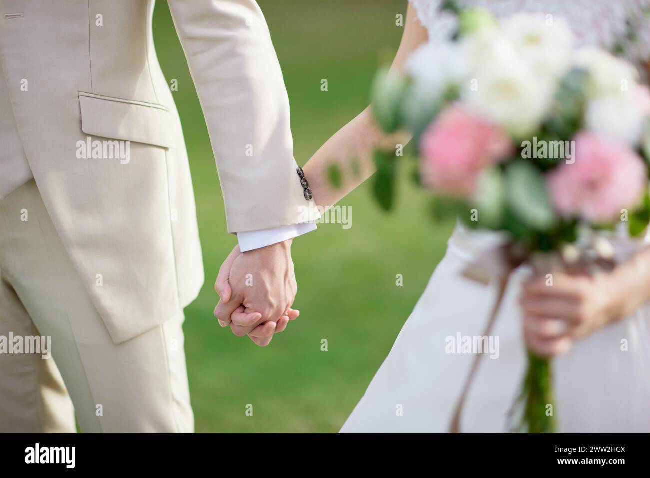 A bride and groom holding hands Stock Photo