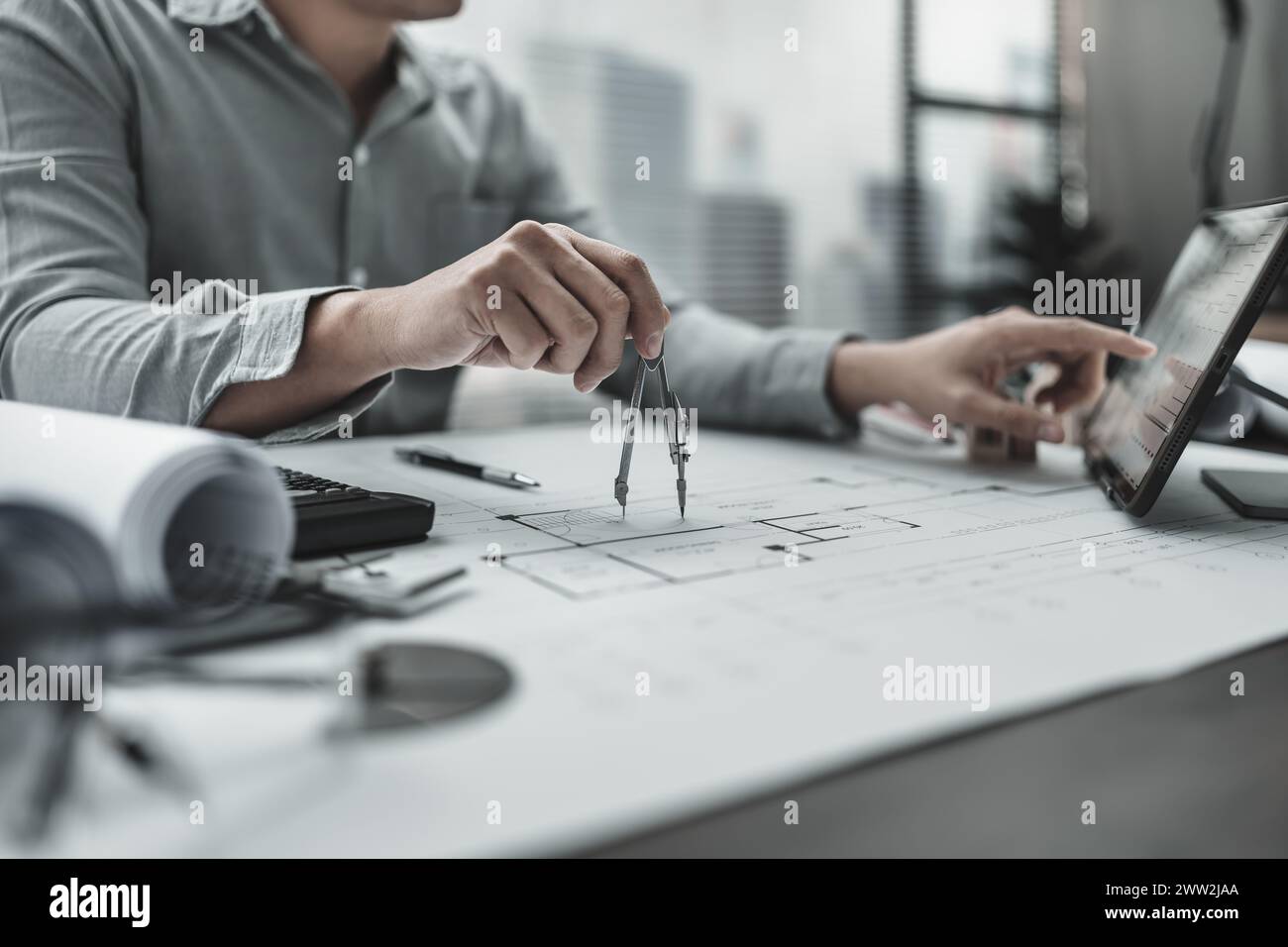 Architect using divider compass working on blueprint.  House planning design and construction concept. Stock Photo