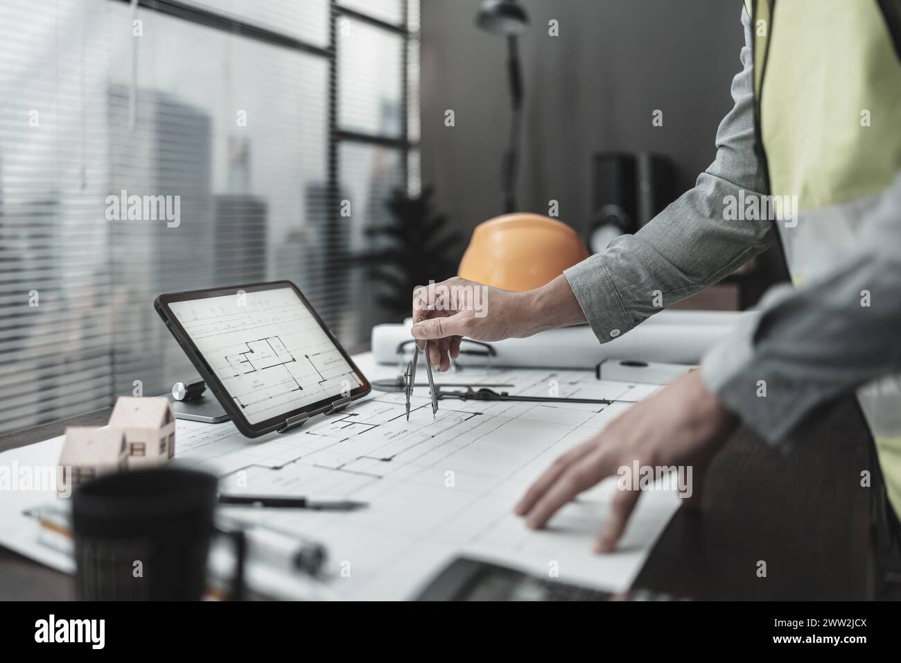 Architect using divider compass working on blueprint.  House planning design and construction concept. Stock Photo