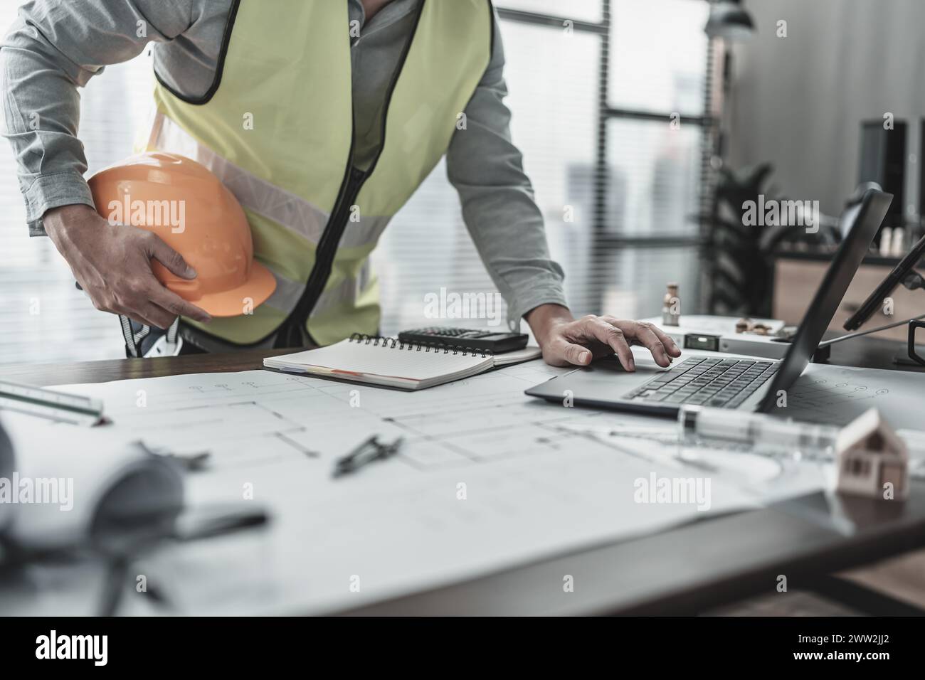 Engineering hold safety helmet working with laptop inspection on the ...
