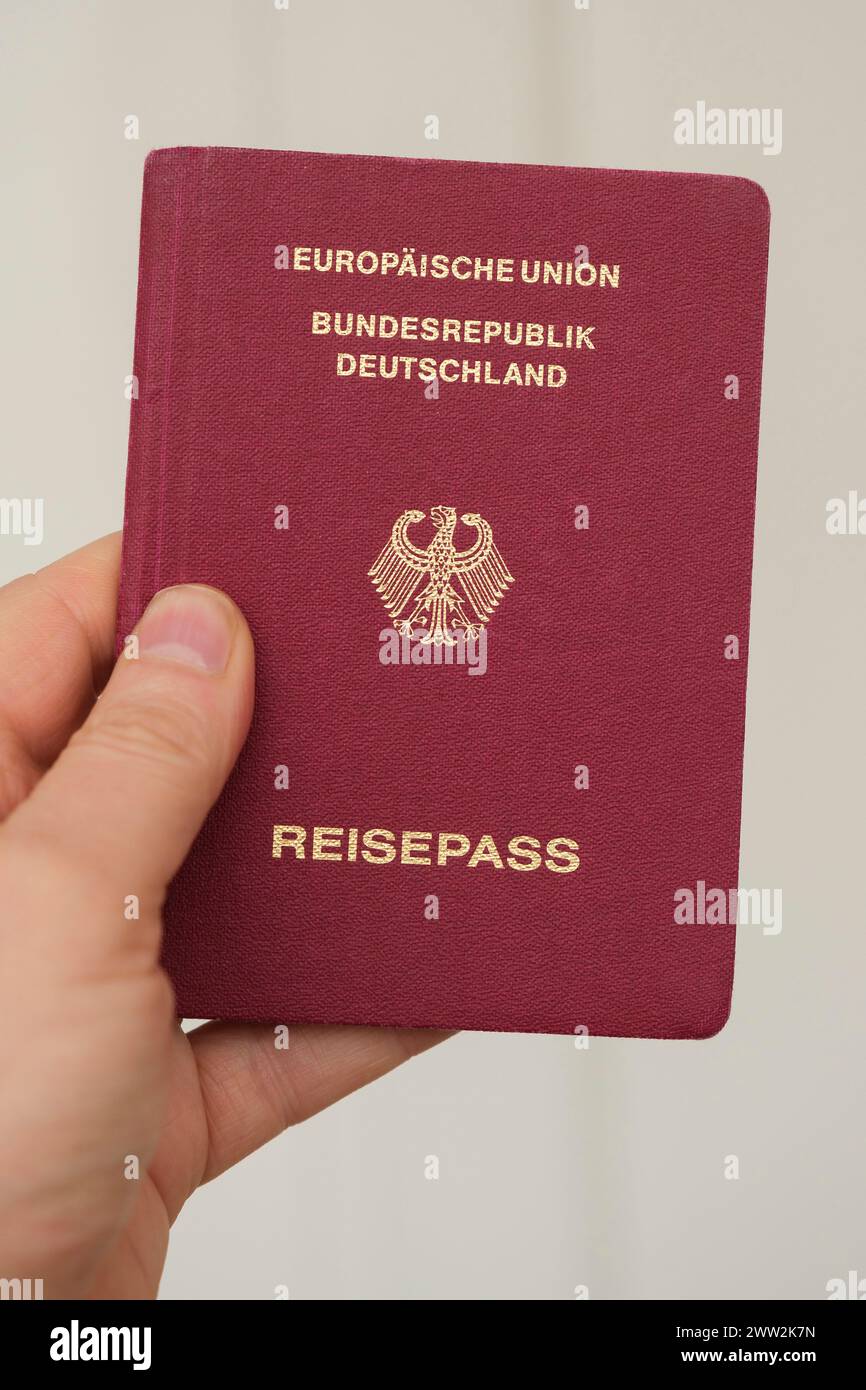 Hand holding a German passport Stock Photo