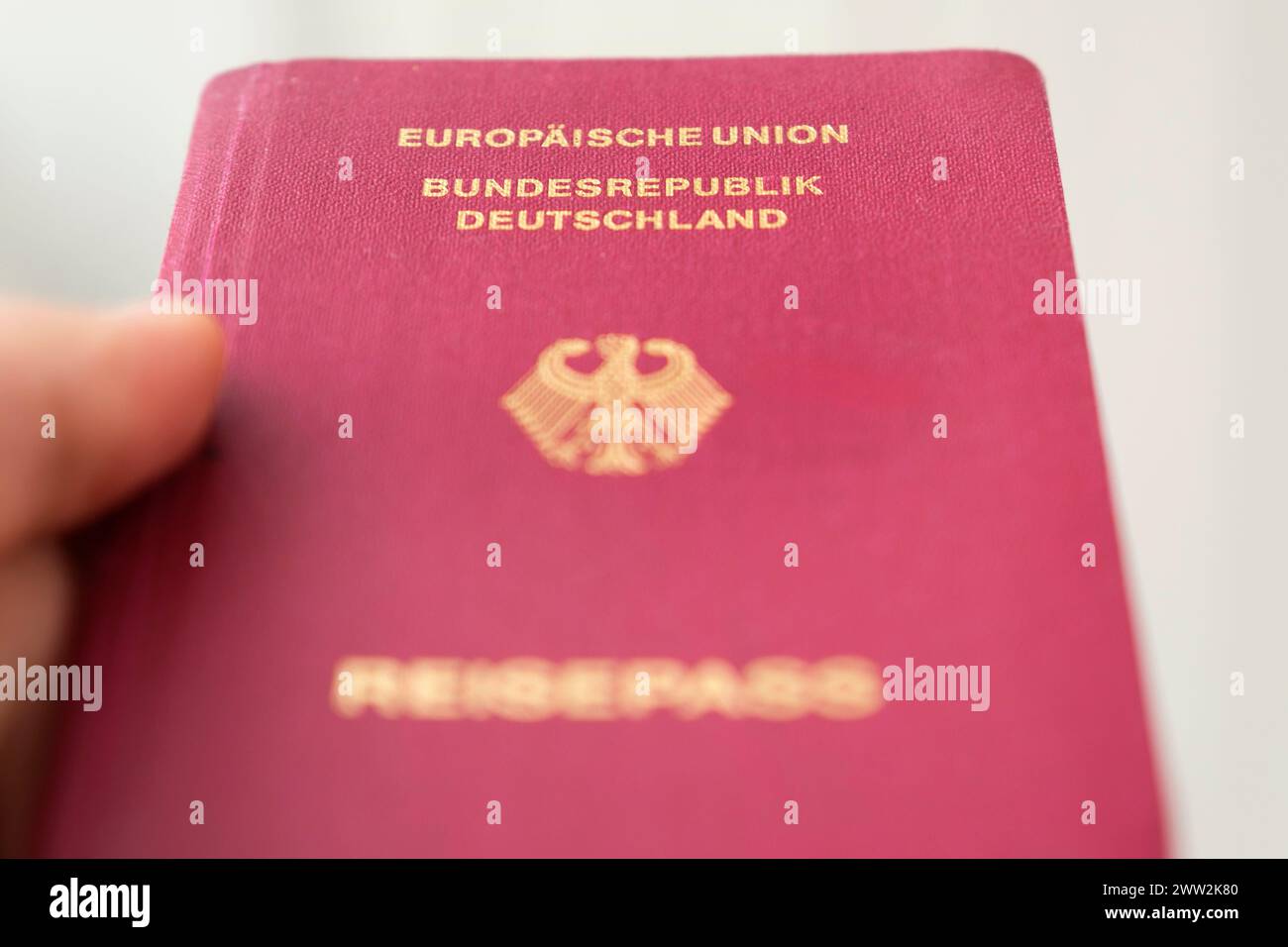 Hand holding a German passport Stock Photo