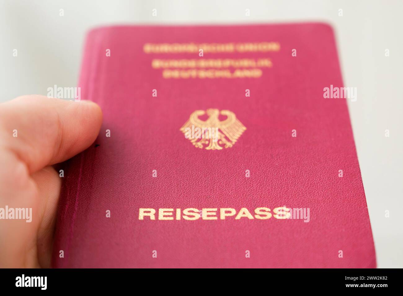 Hand holding a German passport Stock Photo