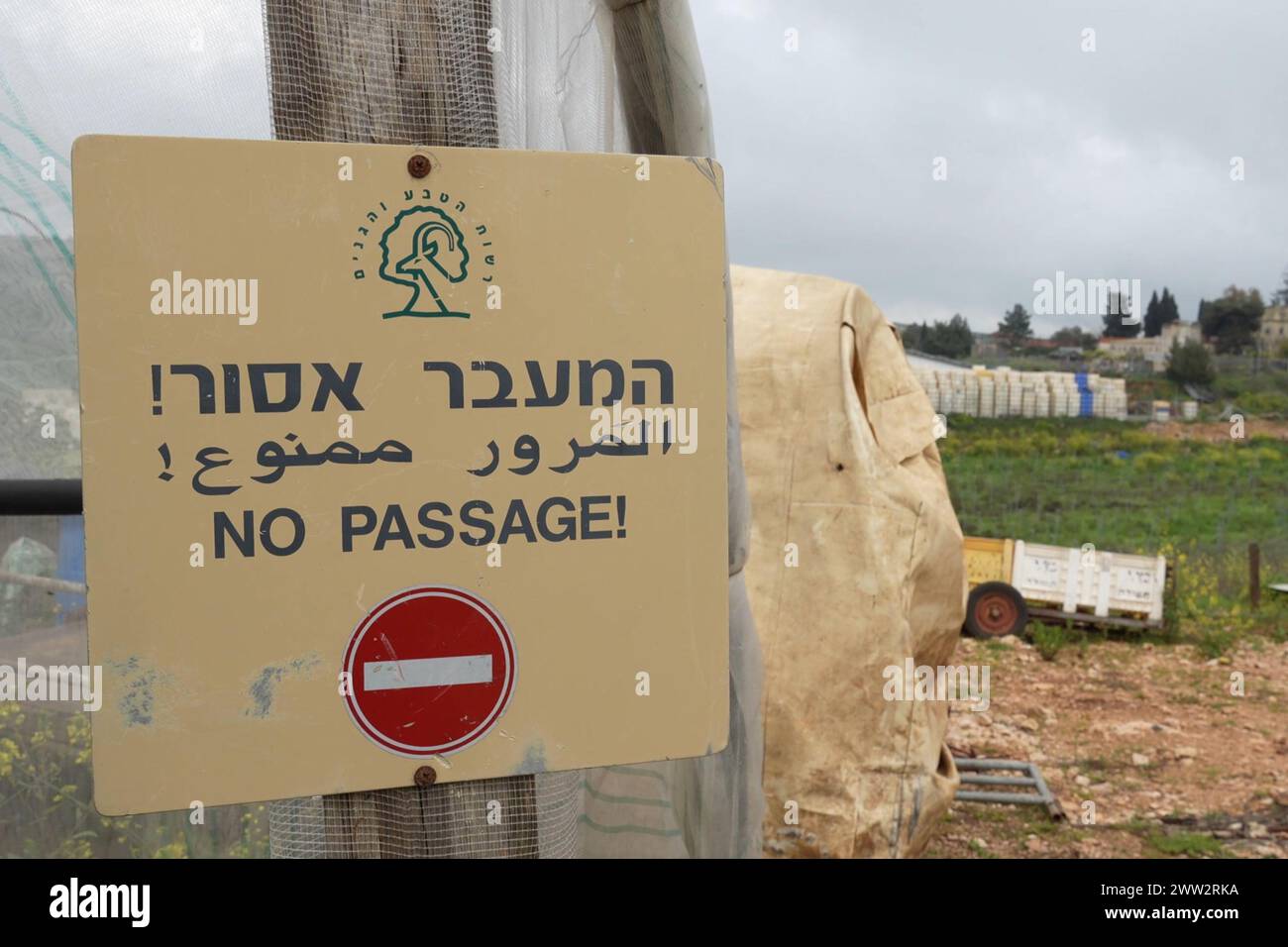 A warning sign that reads 'No Passage!' is displayed at the Israeli town of Metula which is situated near the border with Lebanon and was evacuated from its residents since the cross-border fire began with Hezbollah militant group after the October 7 attacks by Palestinian militants from the Gaza Strip on March 19, 2024 in Metula, Israel. Stock Photo
