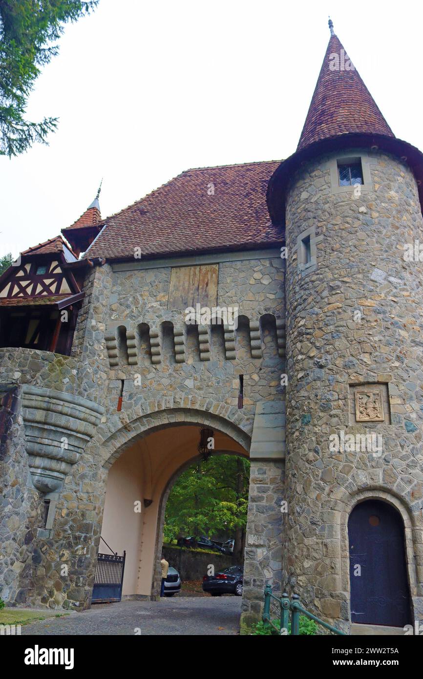 Entrance to the Peles castle, with tradition Romanian houses in Sinaia, Romania Stock Photo