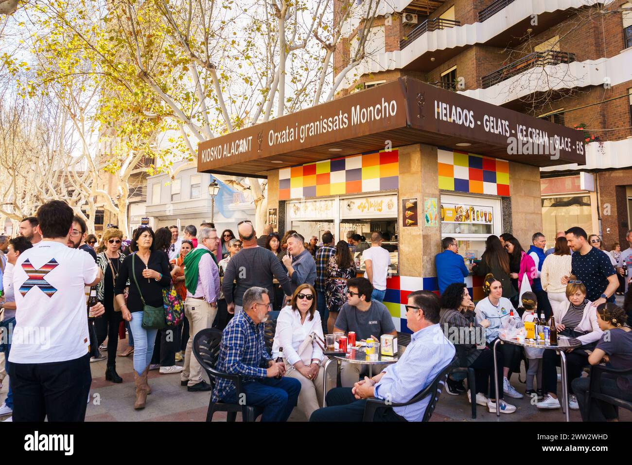 Crowds come to celebrate Las Fallas in celebration of St Joseph's day at an outdoor cafe in the Valencian town of Oliva, Spain Stock Photo