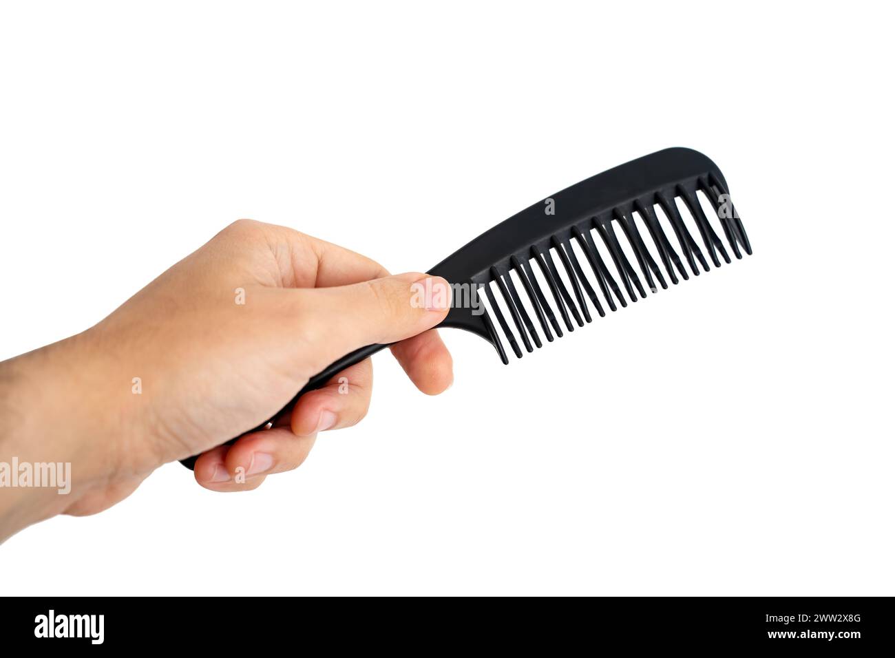 Male Hand Holding A Black Hair Comb, Isolated On White Background Stock Photo