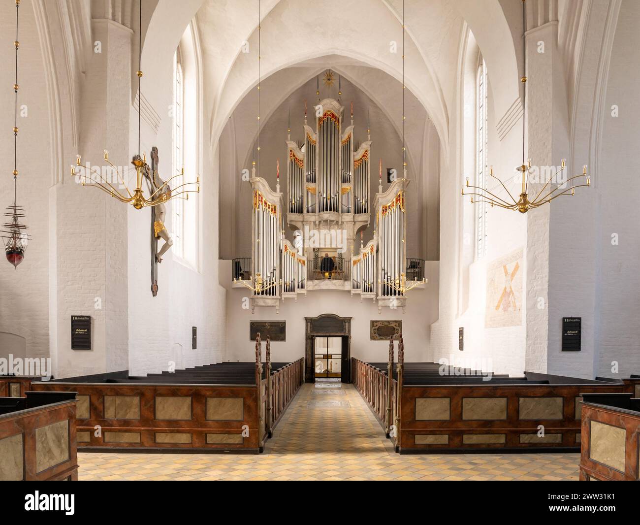 Interior of Mariager Parish Church with organist playing the aubertin pipe organ, Nordjylland, Denmark Stock Photo