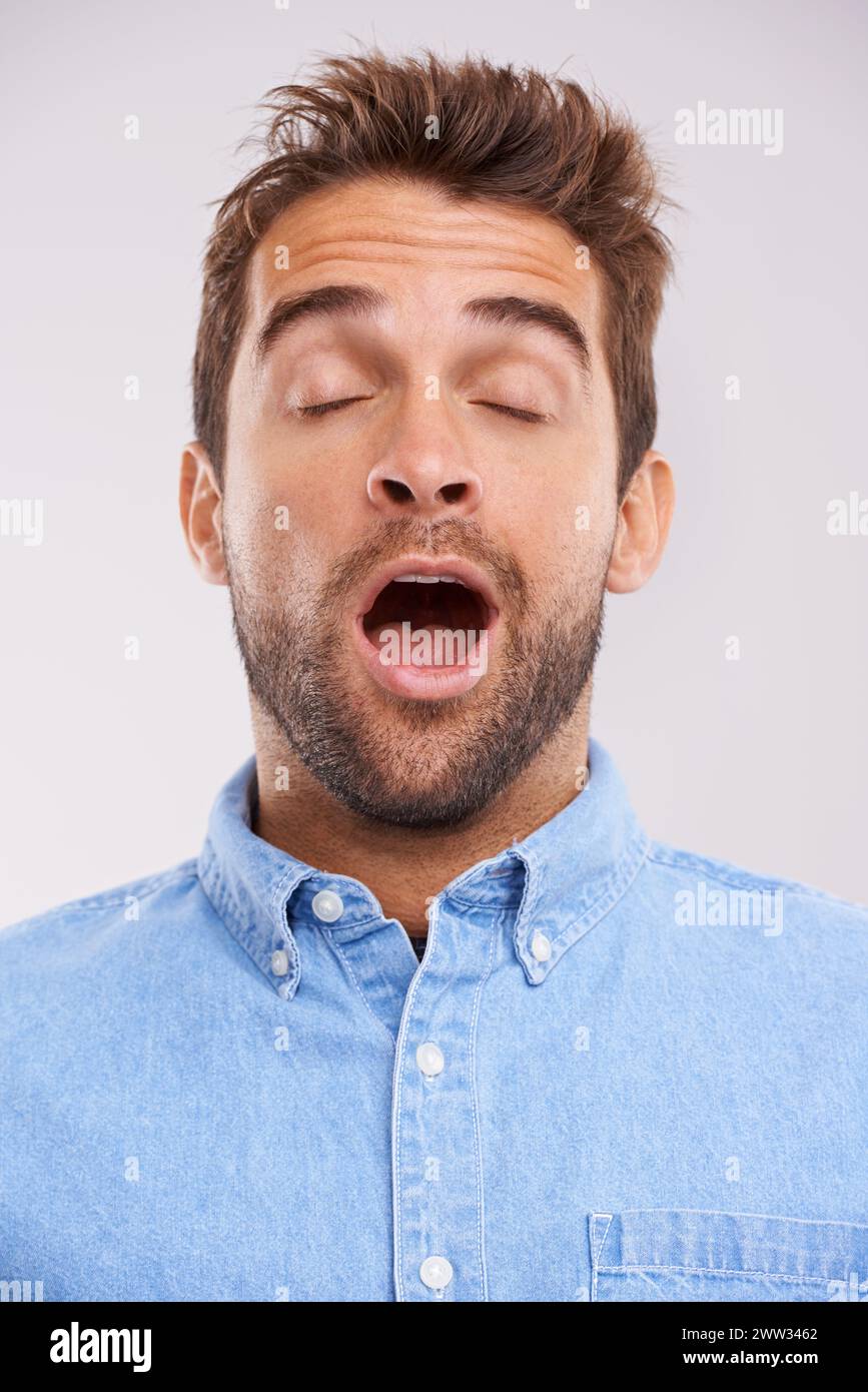 Man, eyes closed and yawn, tired in studio and burnout with facial
