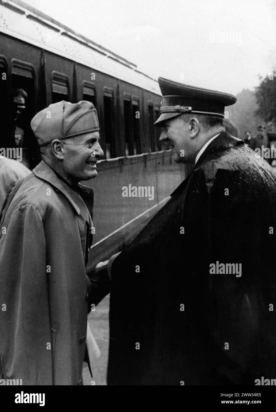 Adolf Hitler greets Benito Mussolini (left) at the train station. 1944 Stock Photo