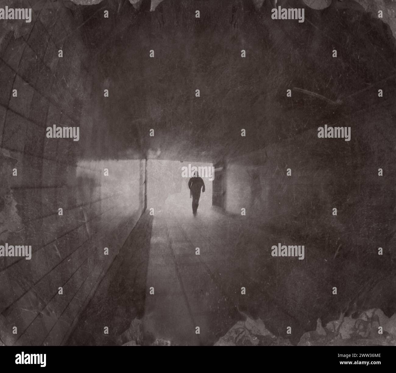 creative grungy image in sepia with scratches and spots of person walking in tunnel. Stock Photo