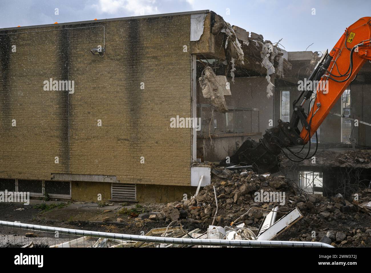 Demolition site (rubble, heavy machinery, building deconstruction, controlled collapse, empty shell) - Baildon library, West Yorkshire, England, UK. Stock Photo