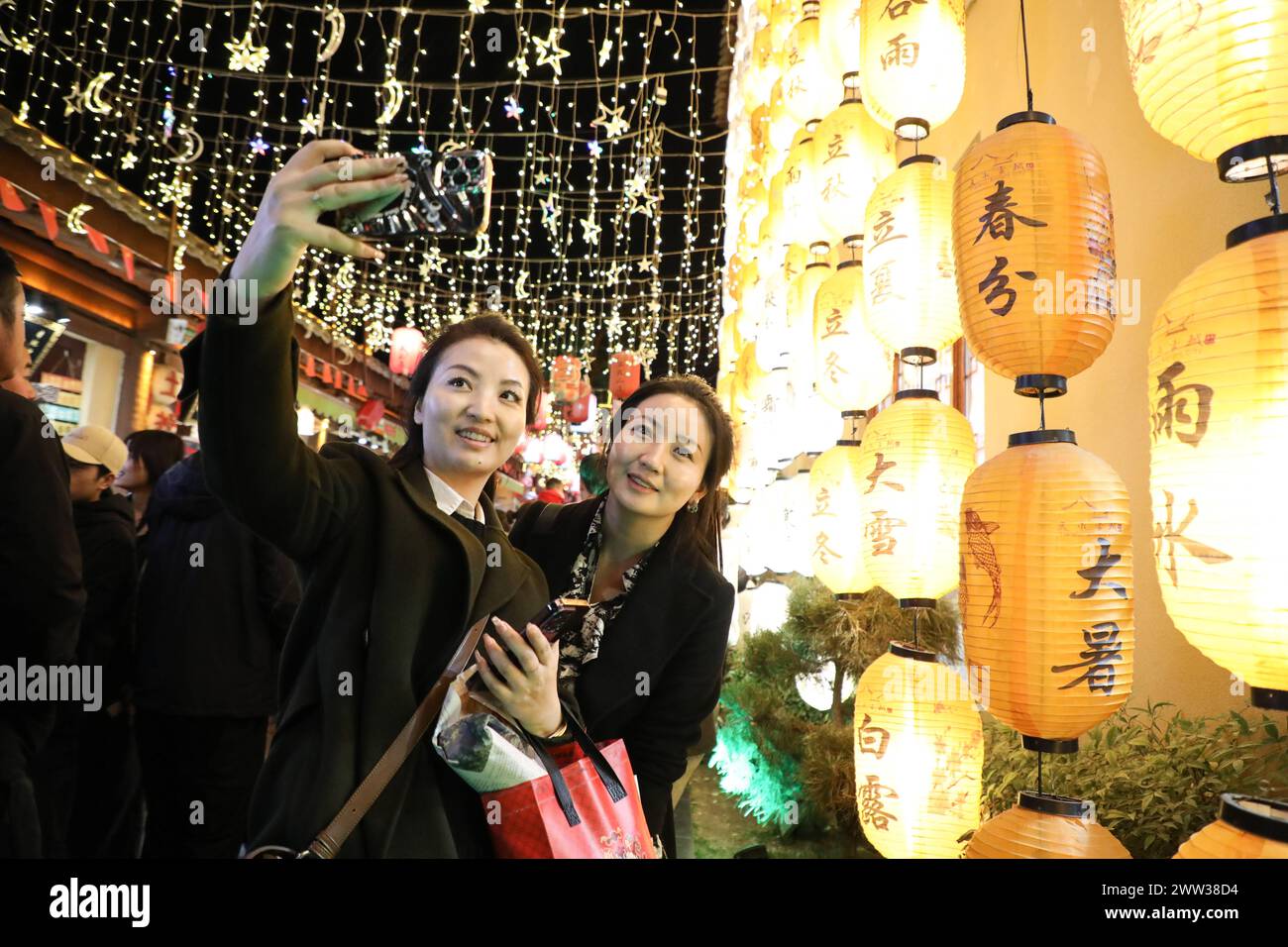 Tianshui, China's Gansu Province. 20th Mar, 2024. Tourists pose for a ...