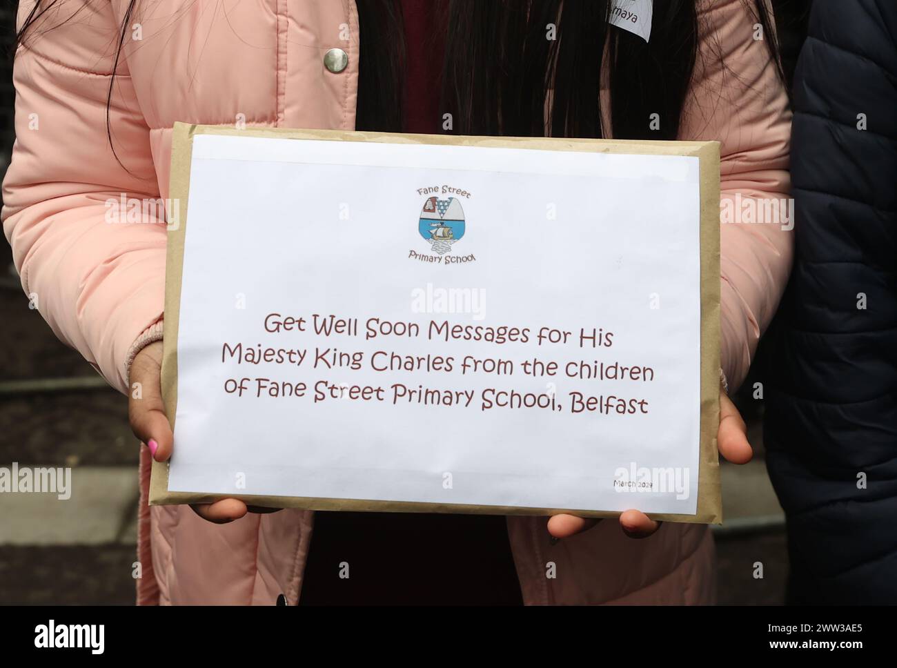 Queen Camilla recieves a message of goodwill during a visit to Lisburn Road in Belfast to meet
