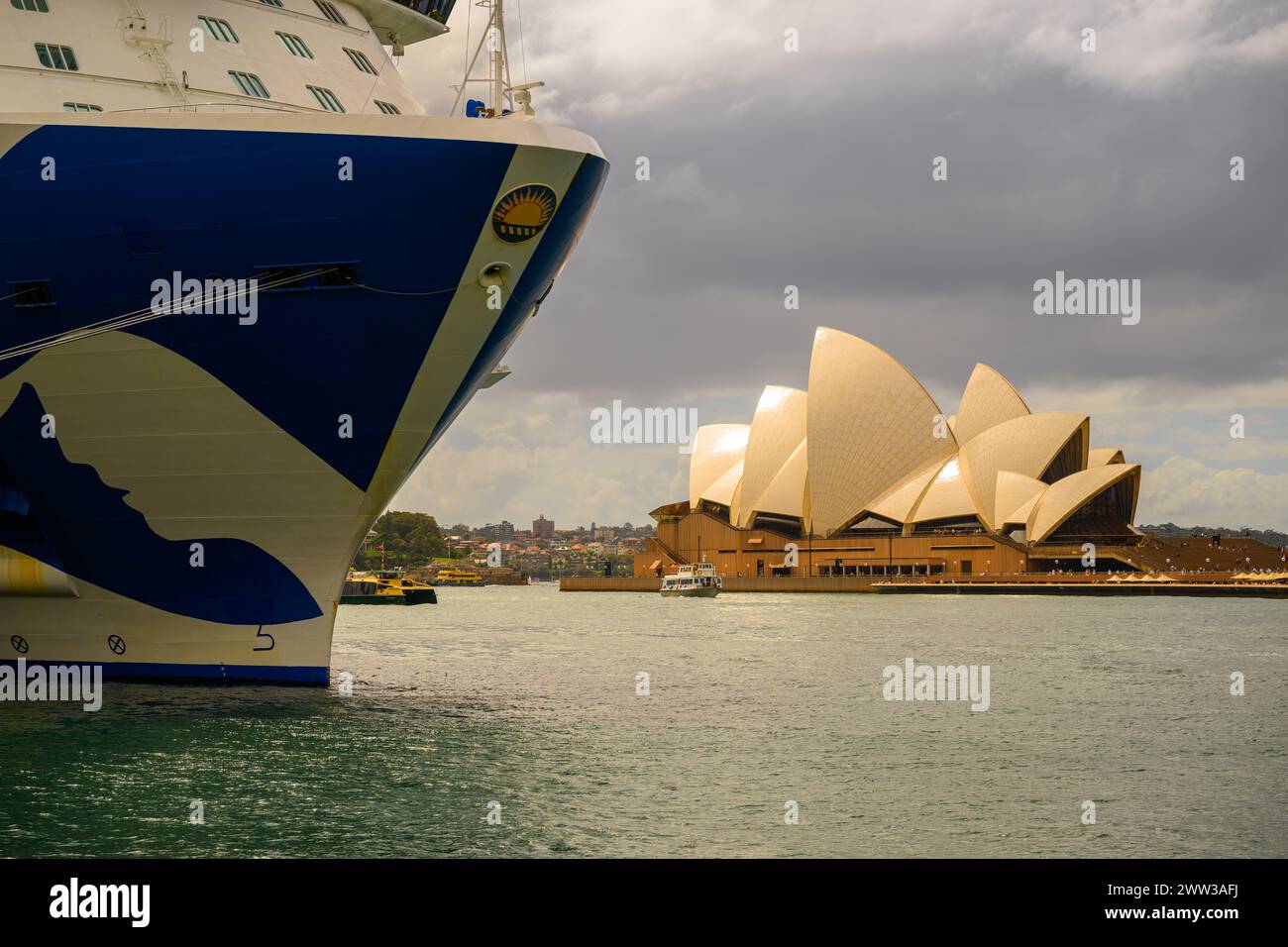 Rear view of the Sydney Opera House with the bow of the Royal Princess cruise ship in the foreground, Sydney Harbour, Australia Stock Photo
