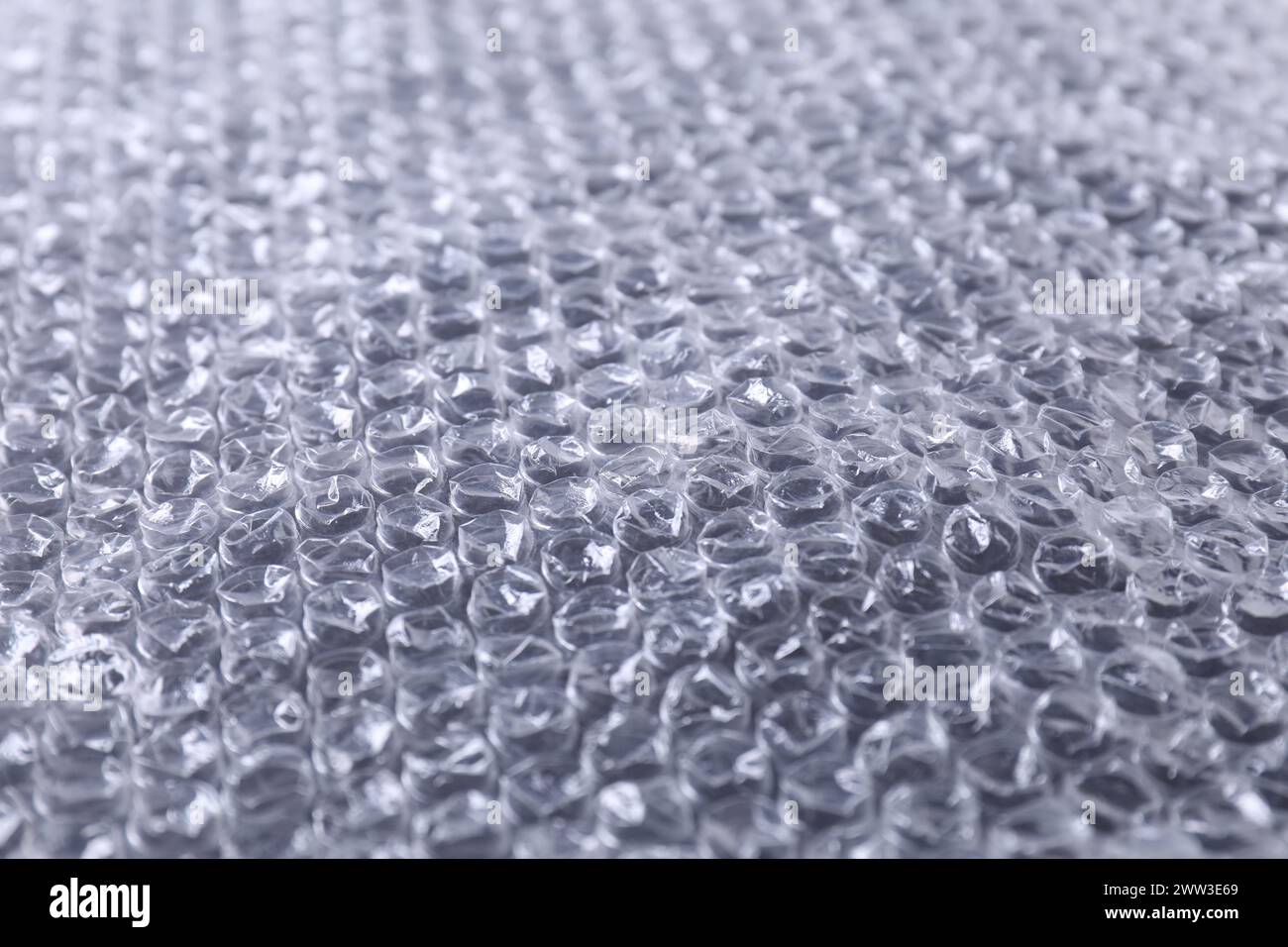 Transparent bubble wrap on black background, closeup Stock Photo