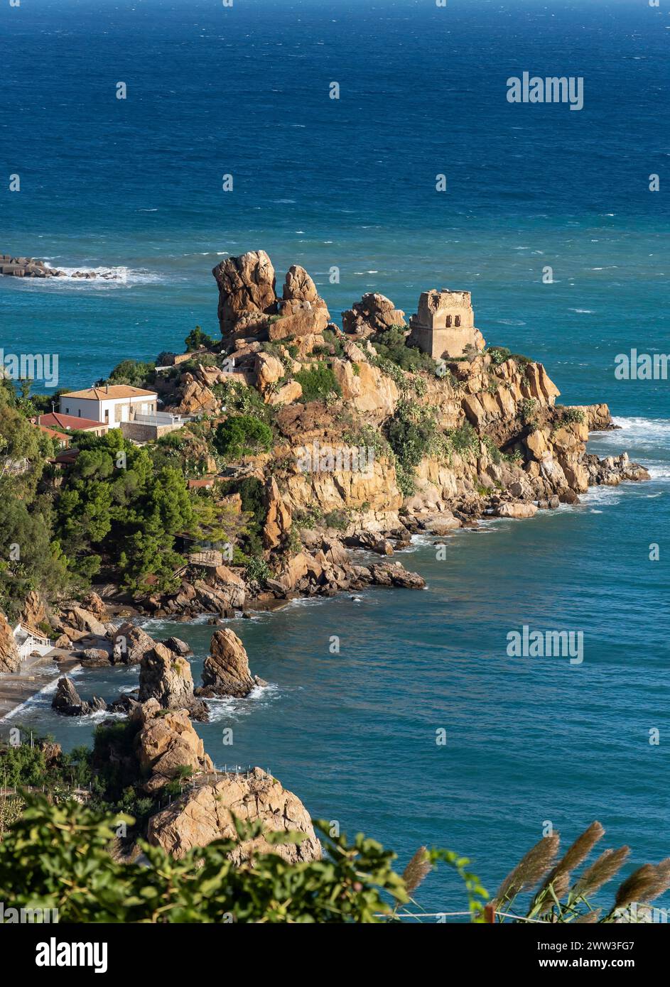 Ruins of Torre Caldura Castle on a rocky promontory jutting into the sea near Cefalu, Sicily, Italy Stock Photo