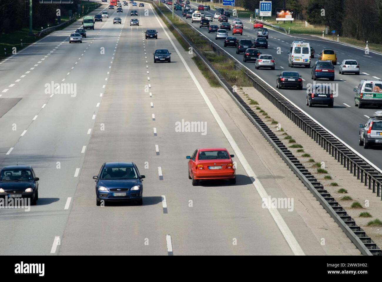 Driver in red BMW driving wrong direction digital composing Germany Stock Photo