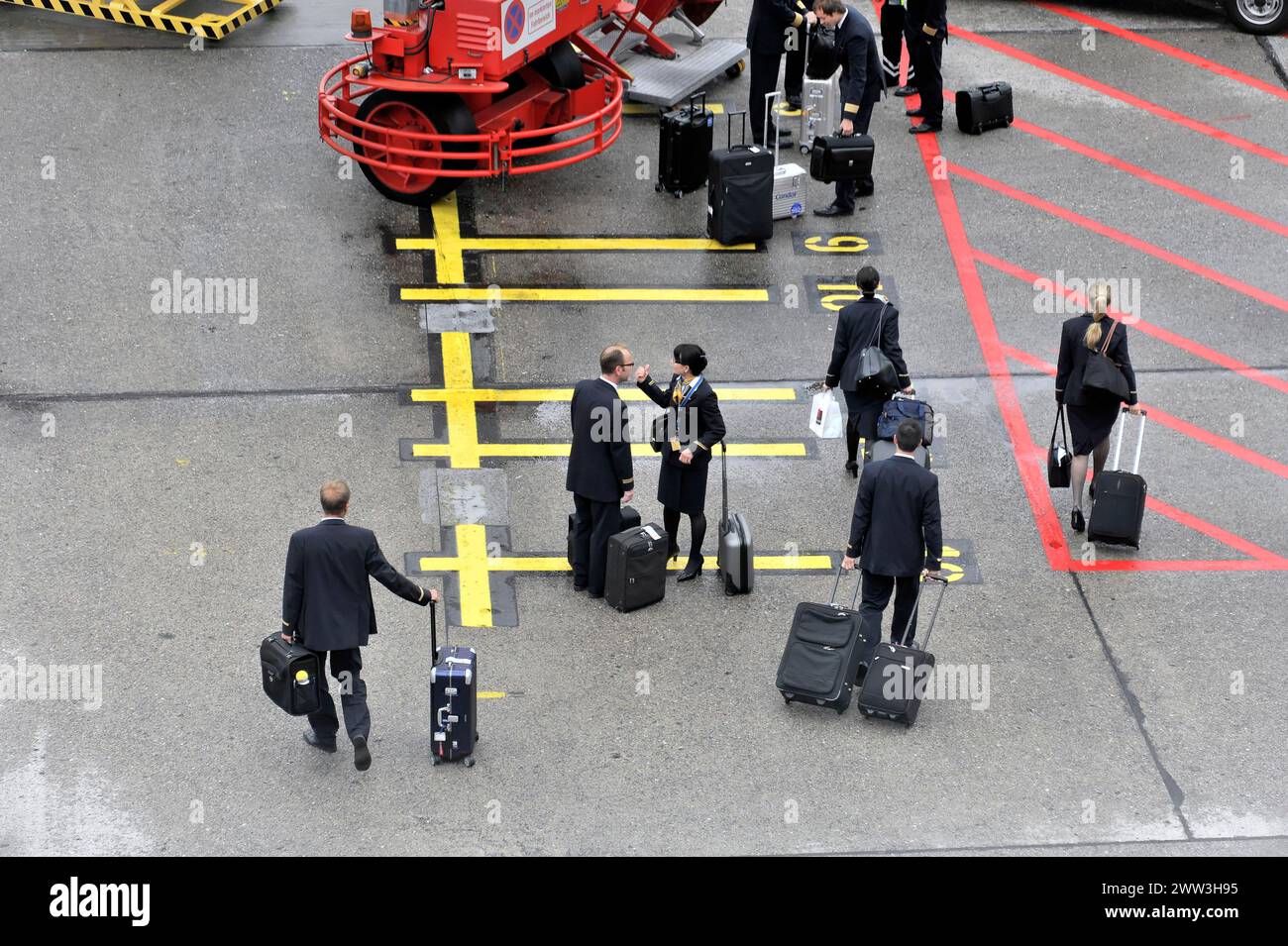 Crew members with wheeled suitcases walking down an aeroplane staircase, Hamburg, Hanseatic City of Hamburg, Germany Stock Photo