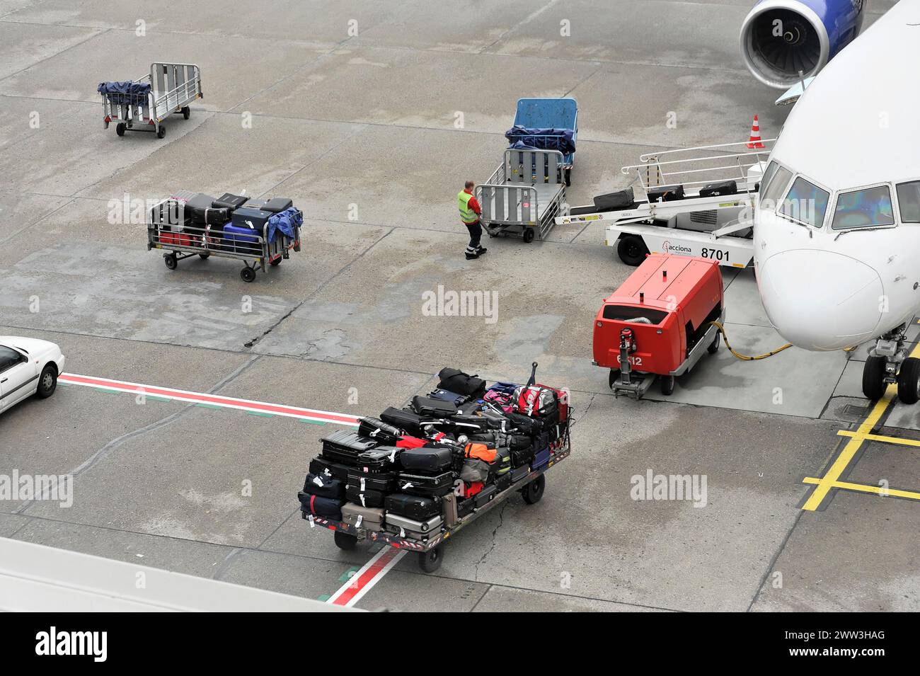 Luggage being loaded onto an aeroplane on an airport tarmac, Hamburg, Hanseatic City of Hamburg, Germany Stock Photo