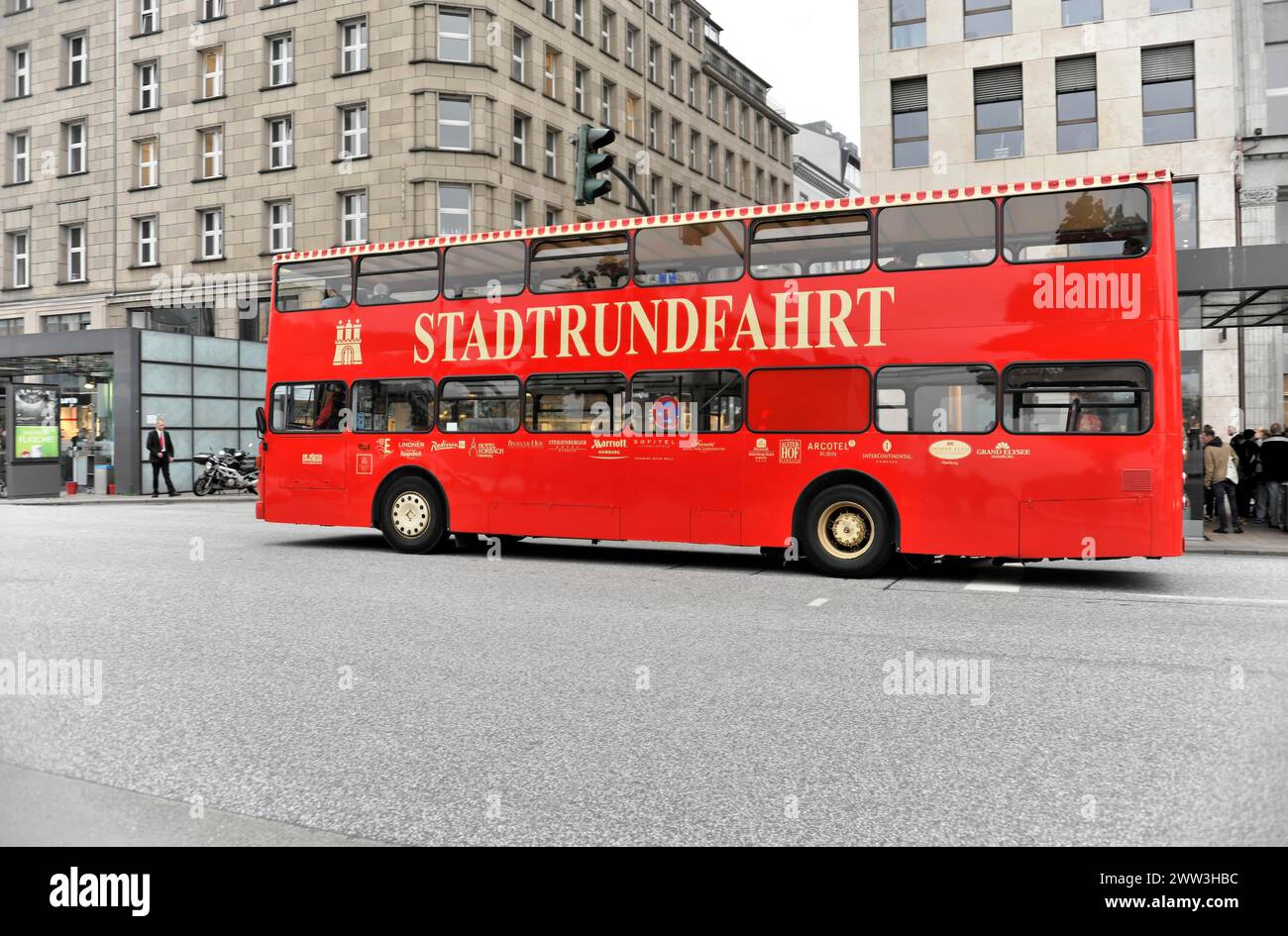 A red sightseeing double-decker bus travelling on a city street, Hamburg, Hanseatic City of Hamburg, Germany Stock Photo