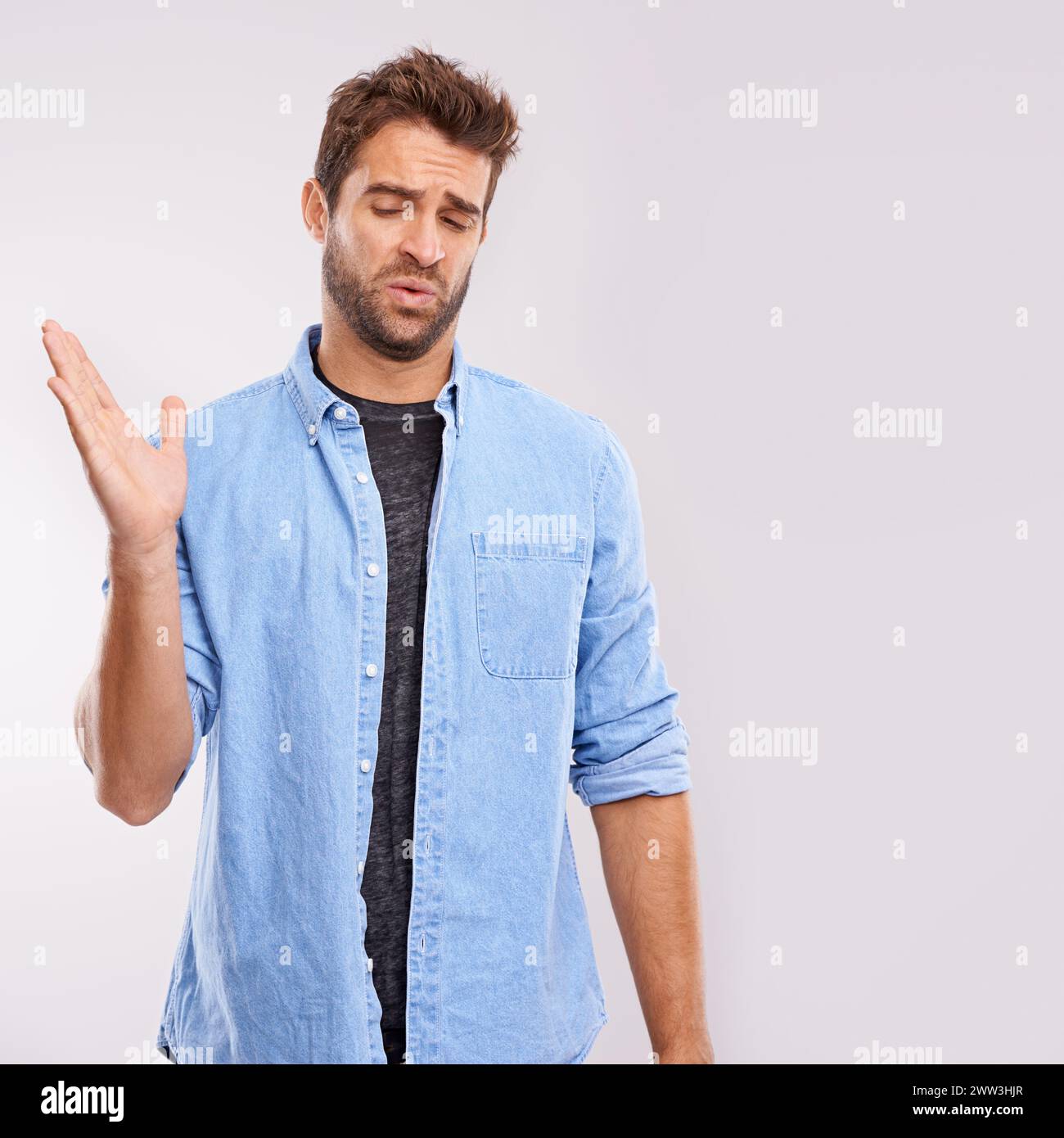 Smell, man and waving his hands for bad stink, poor hygiene and negative aroma on white studio background. Face, person or model with gesture or body Stock Photo