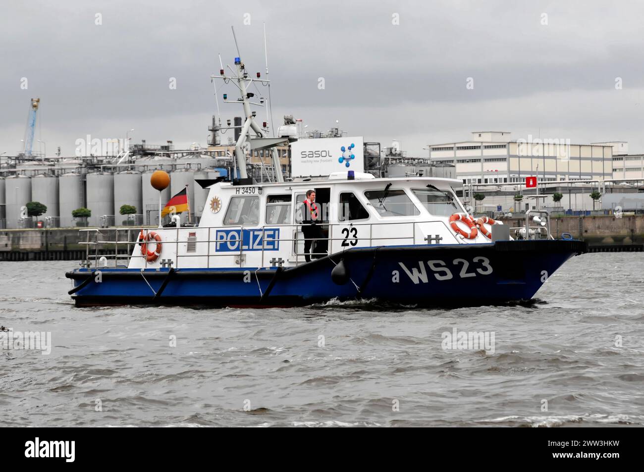 Police boat on the water with crew and cloudy sky in the background, Hamburg, Hanseatic City of Hamburg, Germany Stock Photo