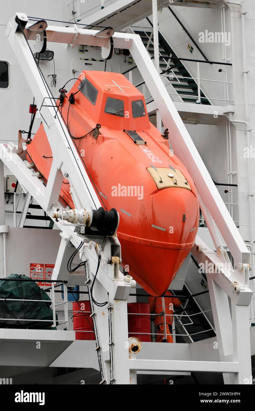 Red lifeboat suspended from a white ship in the harbour, Hamburg, Hanseatic City of Hamburg, Germany Stock Photo