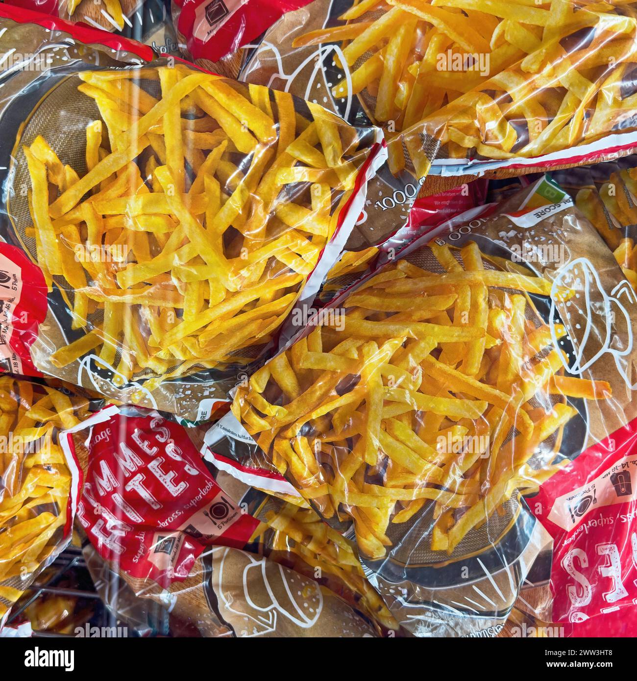 Display of deep-frozen French fries in freezer cabinet with transparent lid of supermarket, Germany Stock Photo