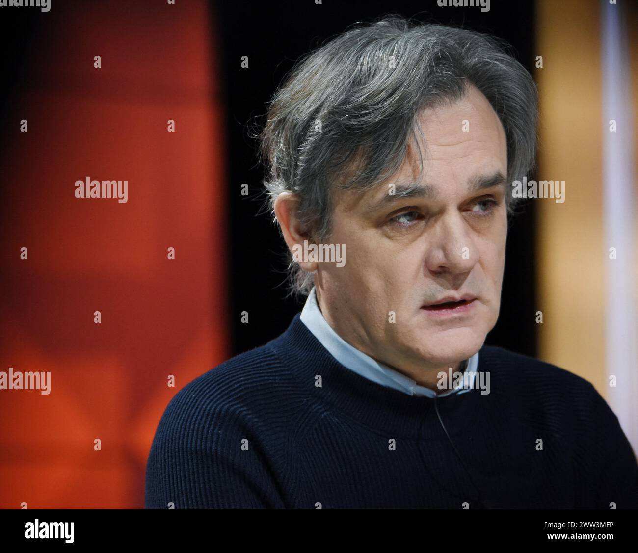 Paris, France. 21st Mar, 2024. Charlie Hebdo director Laurent Sourisseau, know as Riss, appears for an interview on RMC/BFMTV in Paris, France on March 21, 2024 On January 7, 2015 Sourisseau was shot and wounded in the shoulder during the terrorist attack on the Charlie Hebdo office. From the hospital, he drew four cartoons for the issue of Charlie Hebdo released on 14 January. Riss is now the publishing director of the magazine, and he owns 70 % of the shares. Photo by Alain Apaydin/ABACAPRESS.COM Credit: Abaca Press/Alamy Live News Stock Photo
