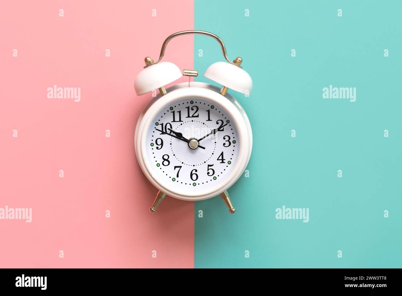 Top view of white alarm clock over pink and blue background Stock Photo ...
