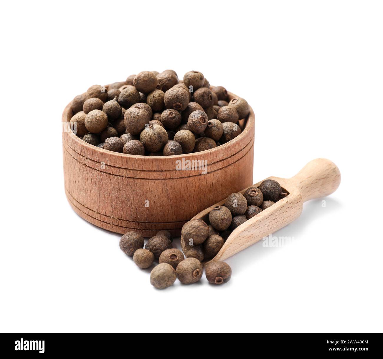 Dry allspice berries (Jamaica pepper) in bowl and scoop isolated on