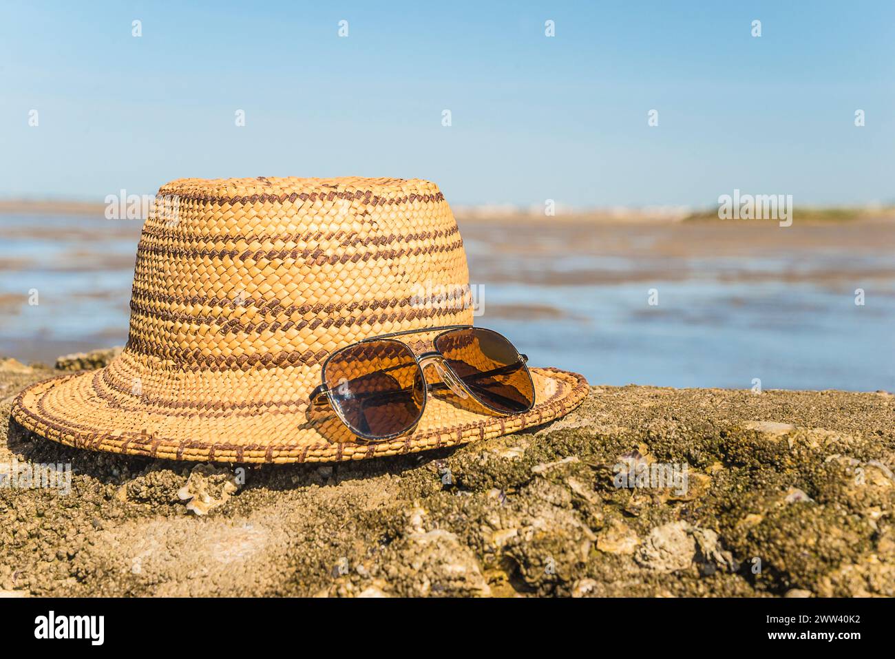straw hat and sunglasses on a atlantic beach Stock Photo - Alamy