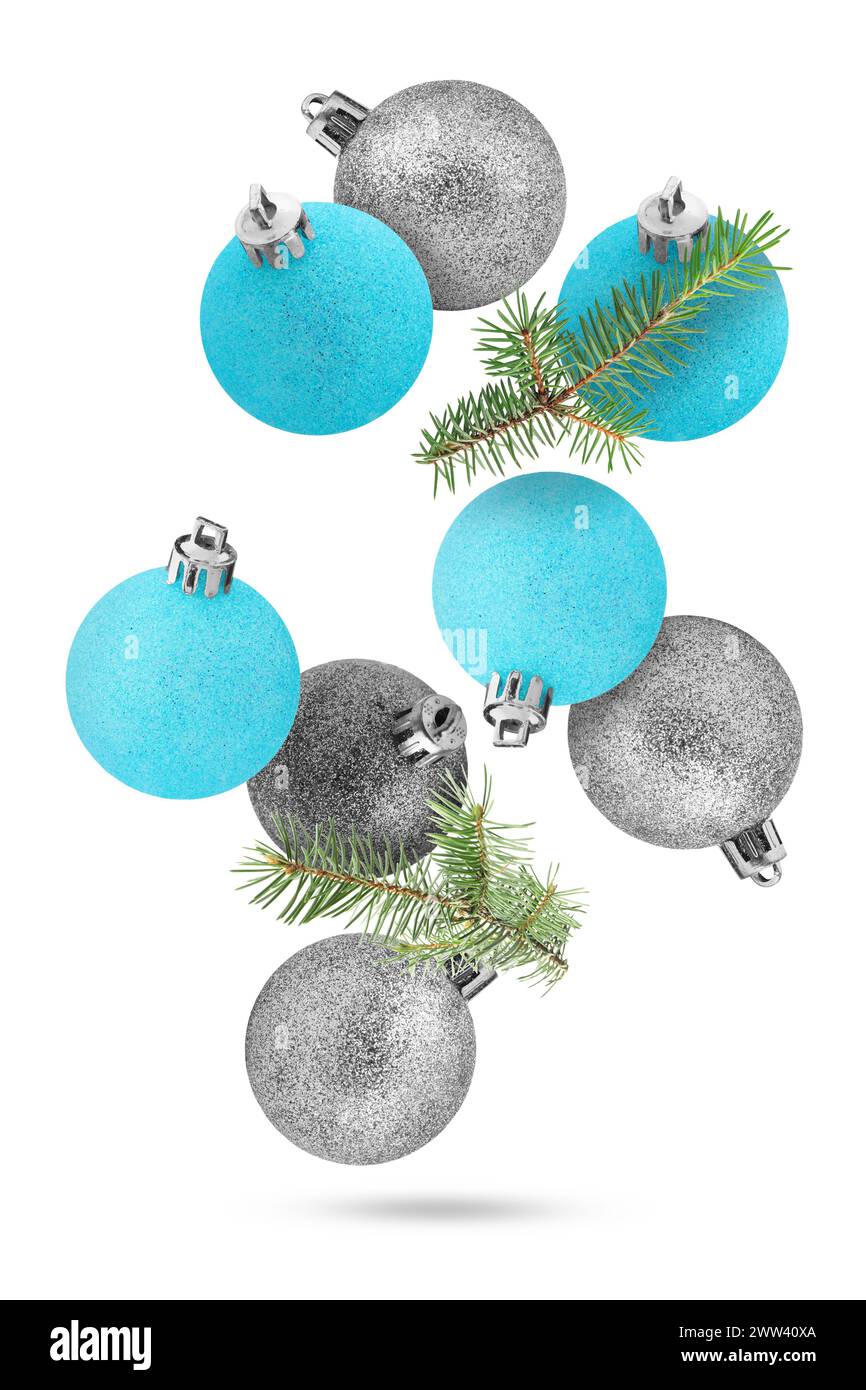 Different Christmas balls and fir tree branches falling on white ...