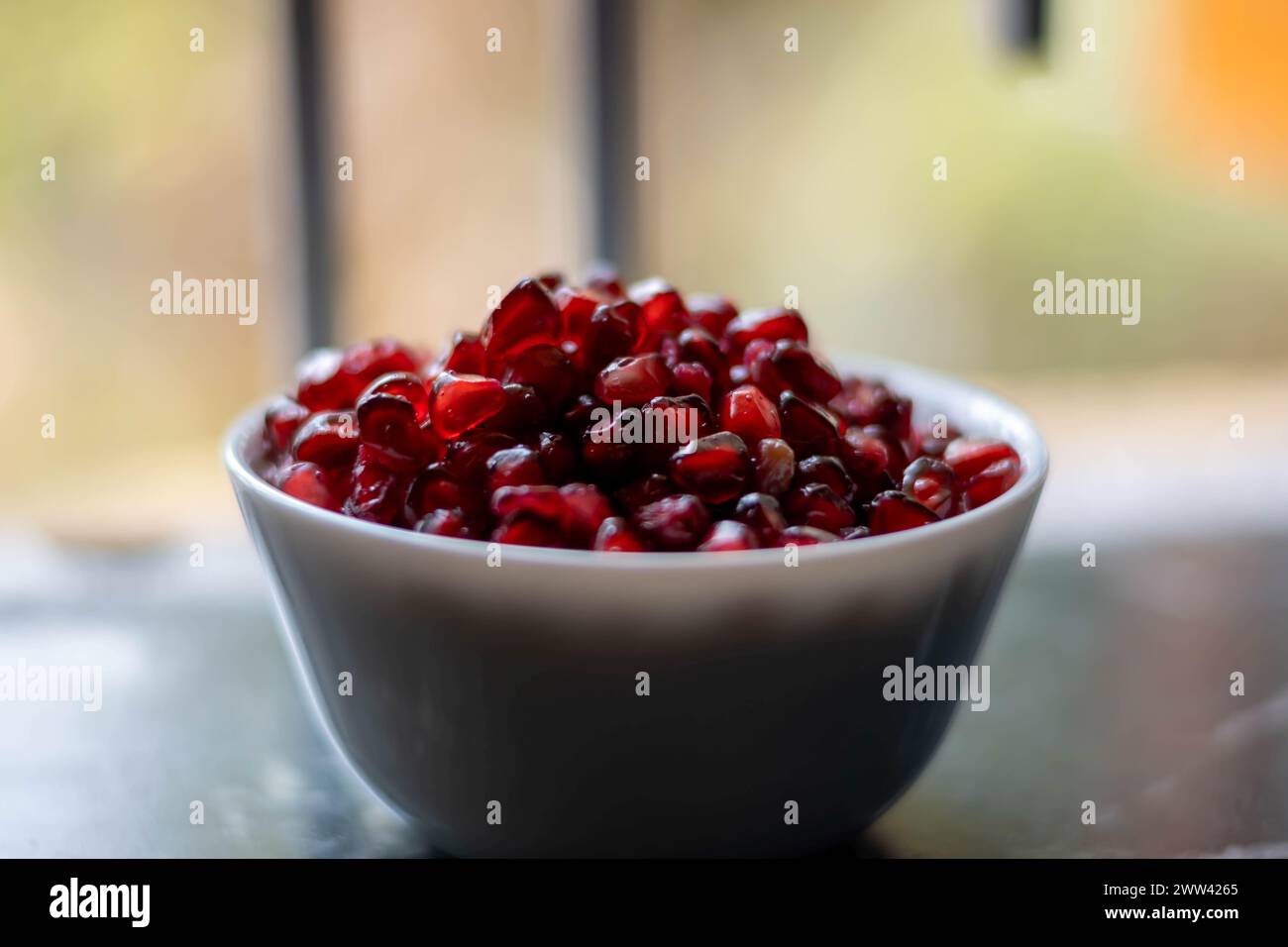 The pomegranate is a fruit-bearing deciduous shrub in the family Lythraceae, subfamily Punicoideae, that grows between 5 and 10 m tall. Stock Photo