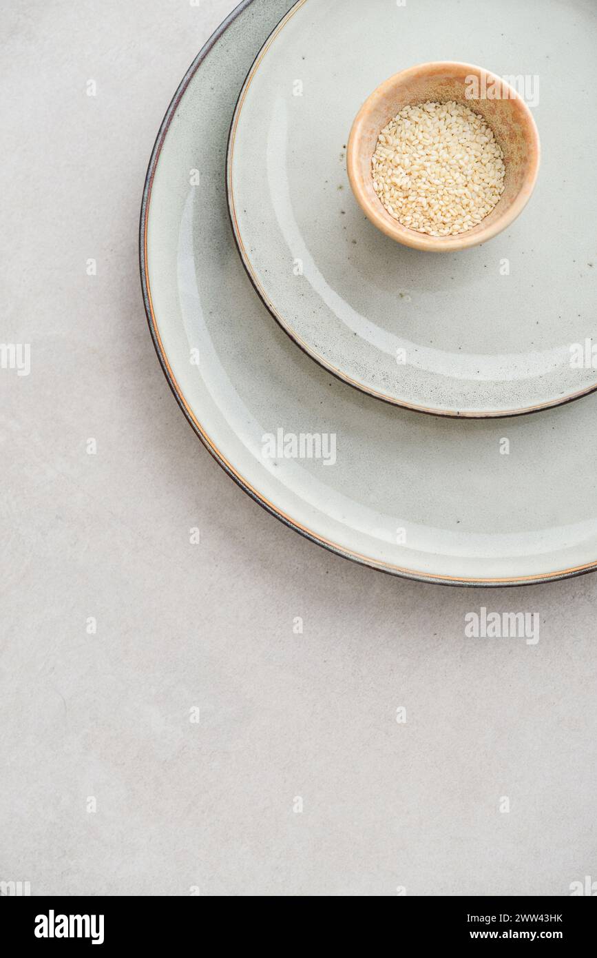 Two plates of different sizes and tiny bowl on light backgrount, top view Stock Photo