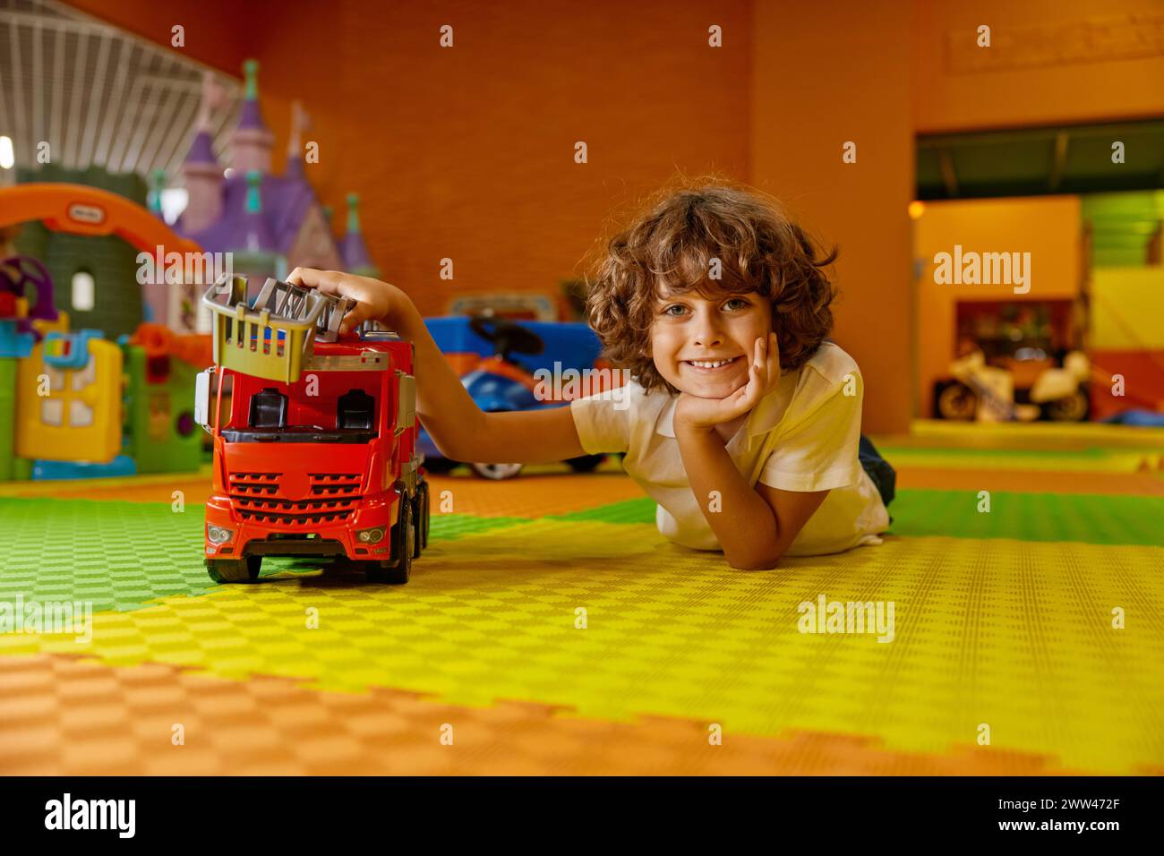 Boy child playing vehicle toys at kids care center Stock Photo - Alamy