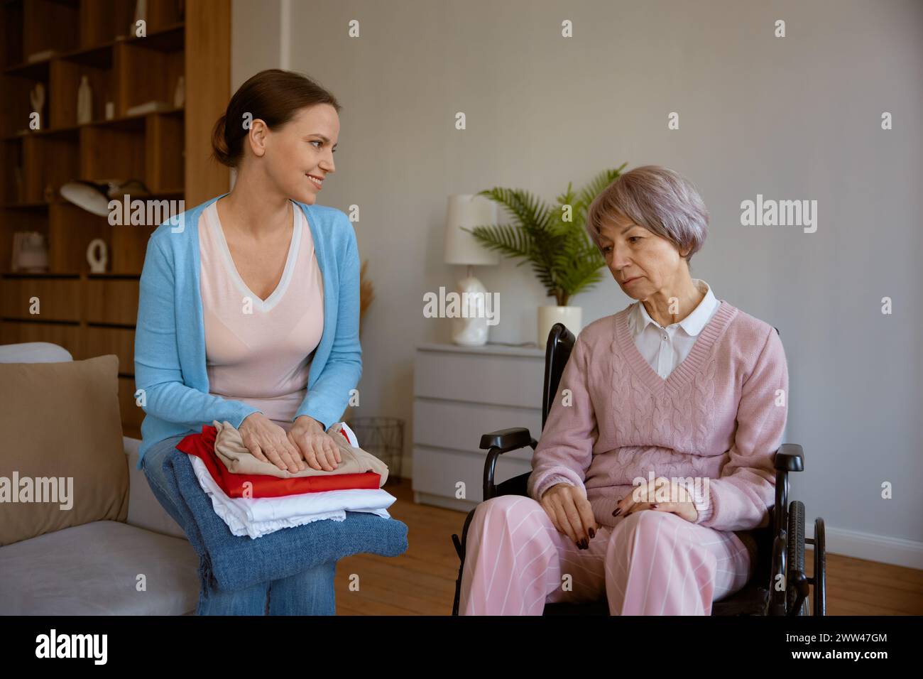 Female nurse talking to her patient during home visit Stock Photo - Alamy