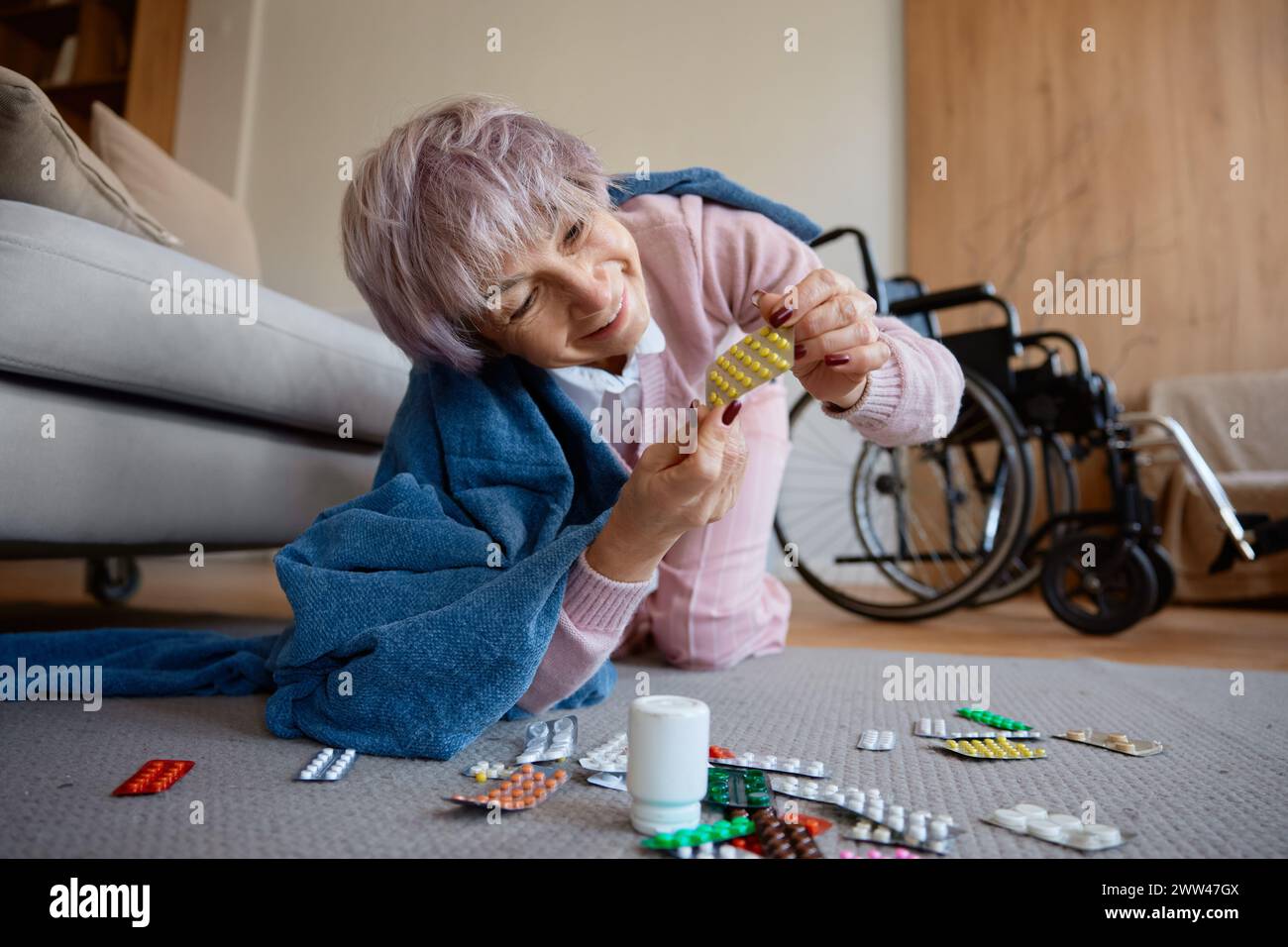 Senior woman with dementia mental disorder eating pills scattered on