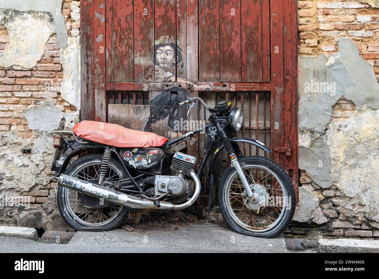 Boy on Motorbike street art mural by Lithuanian artist Ernest Zacharevic in George Town, Penang, Malaysia. Stock Photo