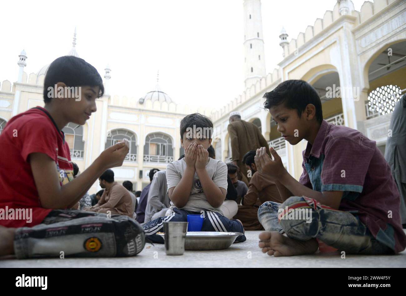 Faithful Muslims are breaking the fast (Iftar) during the Holy month of Ramadan-ul-Mubarak, at Thanvi Mosque located on Lines area in Karachi on Thursday, March 21, 2024. Stock Photo