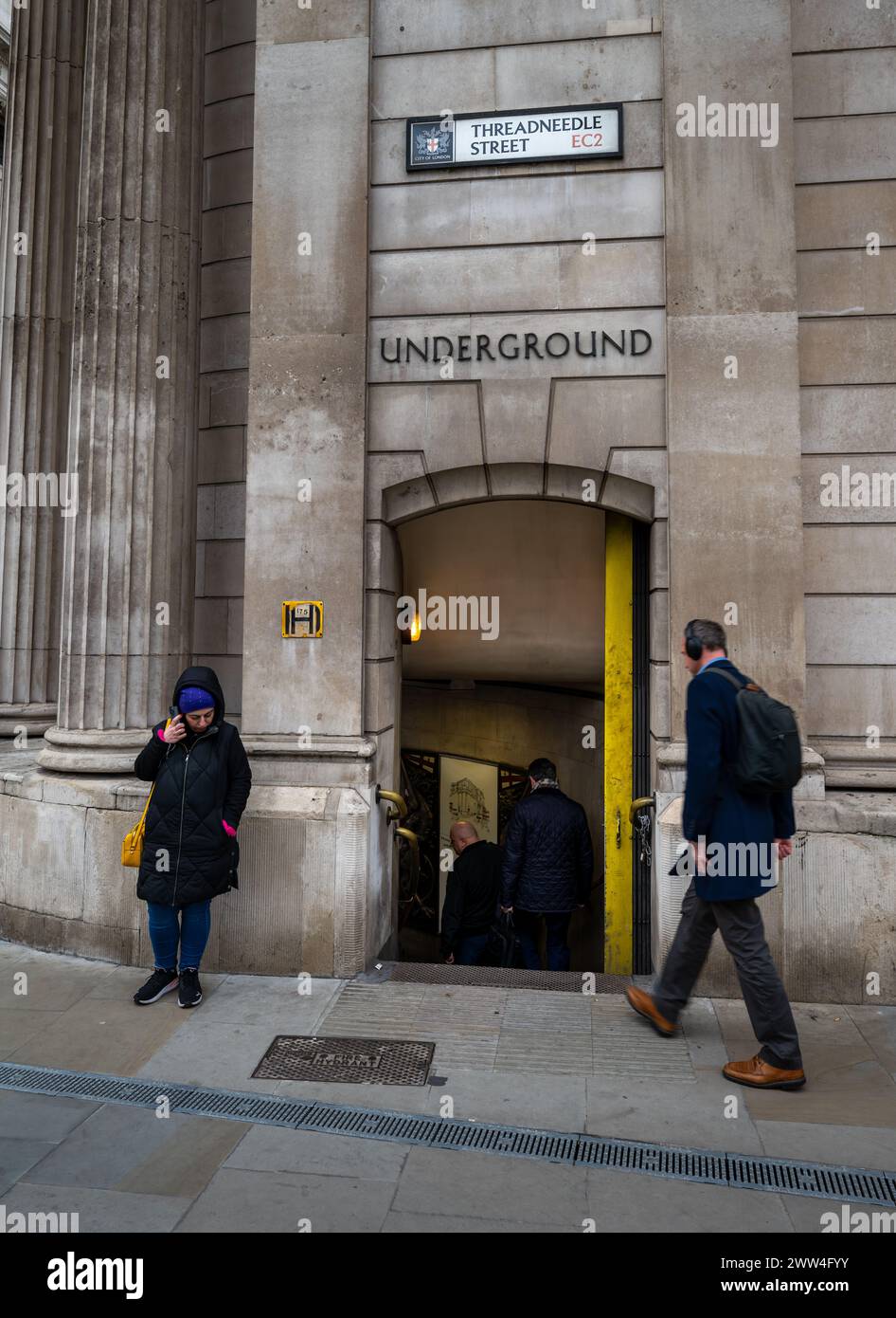 London, UK: An entrance to Bank Underground Station on Threadneedle Street in the City of London. People are entering the tube station. Stock Photo