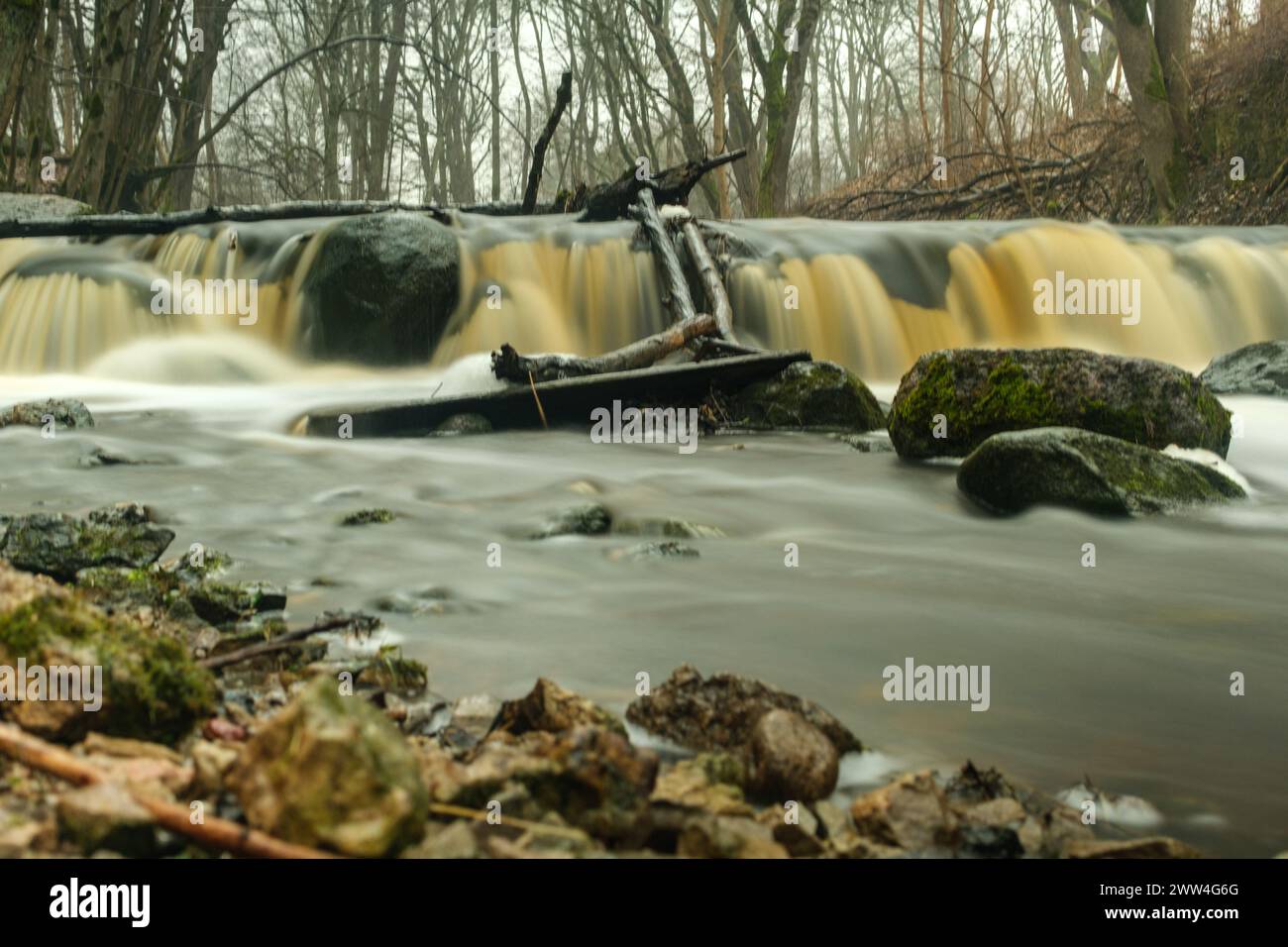 Experience the splendor of Ivandes waterfall in long exposure, where time stands still to unveil the enchanting allure of Latvia's natural wonders Stock Photo